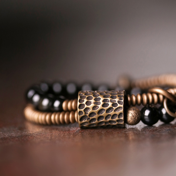 Men's bead bracelet with silver-toned accents and dark natural beads