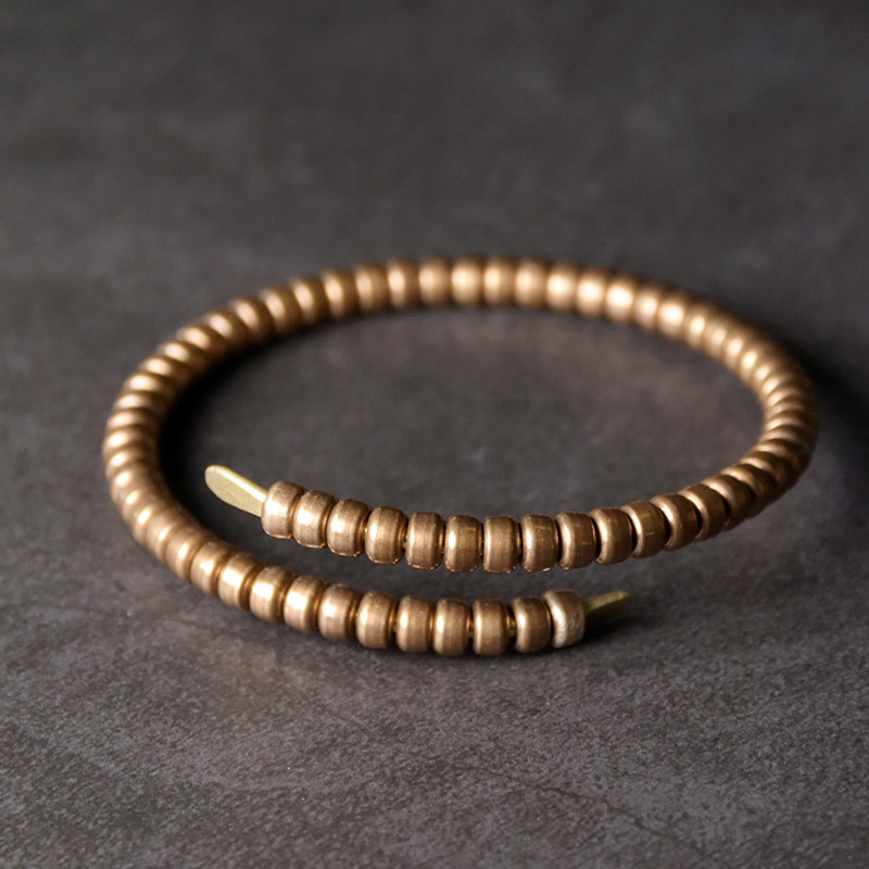 Textured brass cuff bracelet showing a warm gold-toned surface